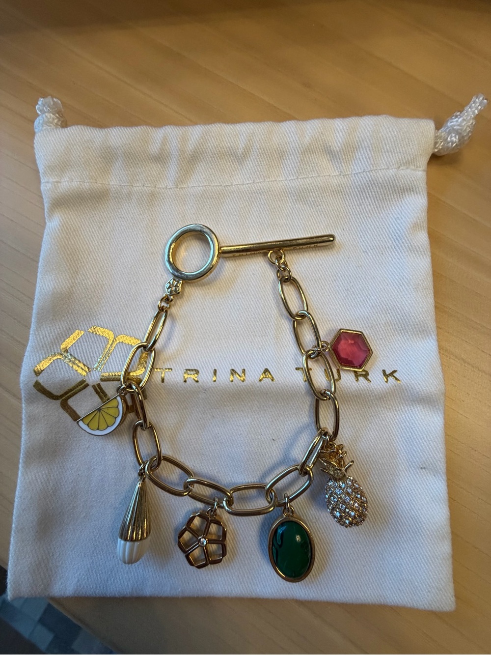 Trina Turk Gold Charm Bracelet with Green and Pink Accents